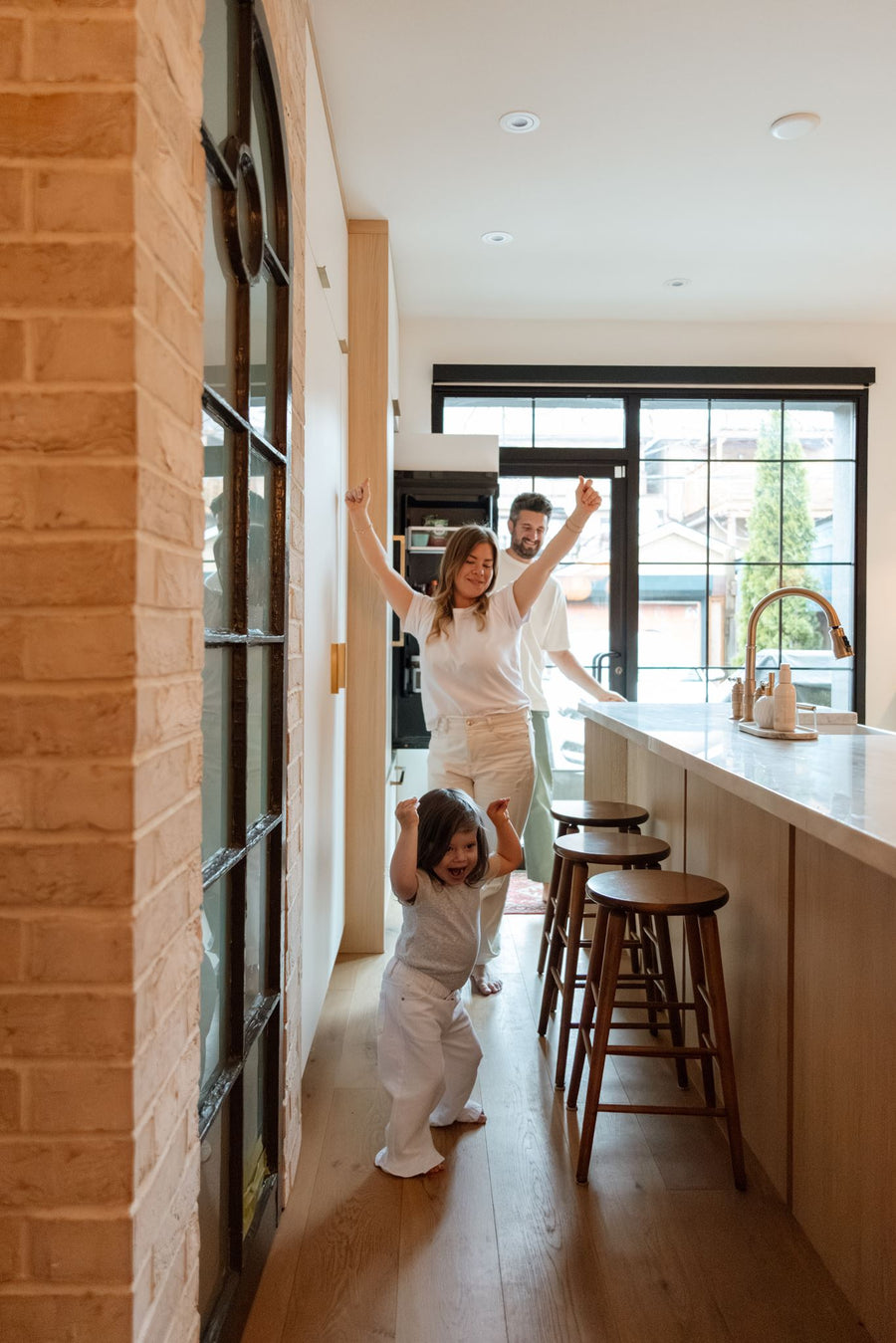 Two kids eating breakfast together at the kitchen table